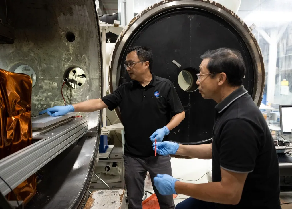 Yi Lin, left, SPEARS testing and research lead, and Ji Su, a polymer materials scientist and the task lead, during the removal of SPEARS batteries from thermal vacuum testing at NASA Langley.
