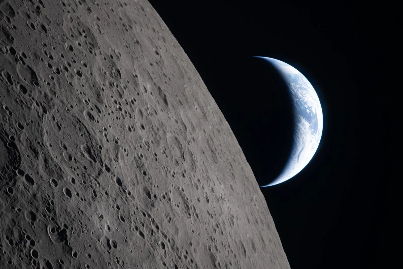 As the Artemis II crew members came close to passing behind the Moon and experiencing a planned loss of signal, they captured this image of a crescent Earth setting on the Moon’s limb on April 6, 2026