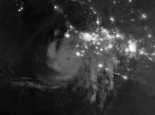 Gravity waves in the upper atmosphere appear as a semicircle of ripples in a nighttime, grayscale satellite image. Hurricane clouds and city lights in Mexico are also visible.