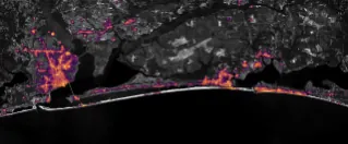 Nighttime lights along the Florida Panhandle coast in August 2026, brightest in Pensacola and Destin and along the road between them.