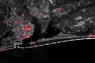 Nighttime lights along the Florida Panhandle coast on October 11, 2026, after Hurricane Isaias, with fewer and dimmer lights in Pensacola and Destin and gaps along the road between them.