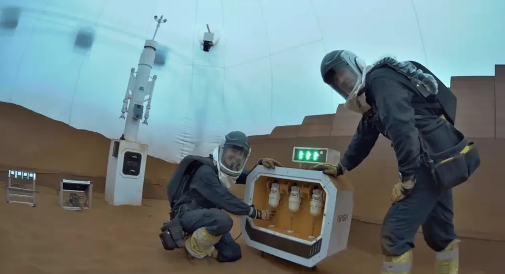 CHAPEA Mission 2 crew members Ellen Ellis (left) and Ross Elder (right) conduct a maintenance task during a simulated extravehicular activity, also known as a spacewalk.